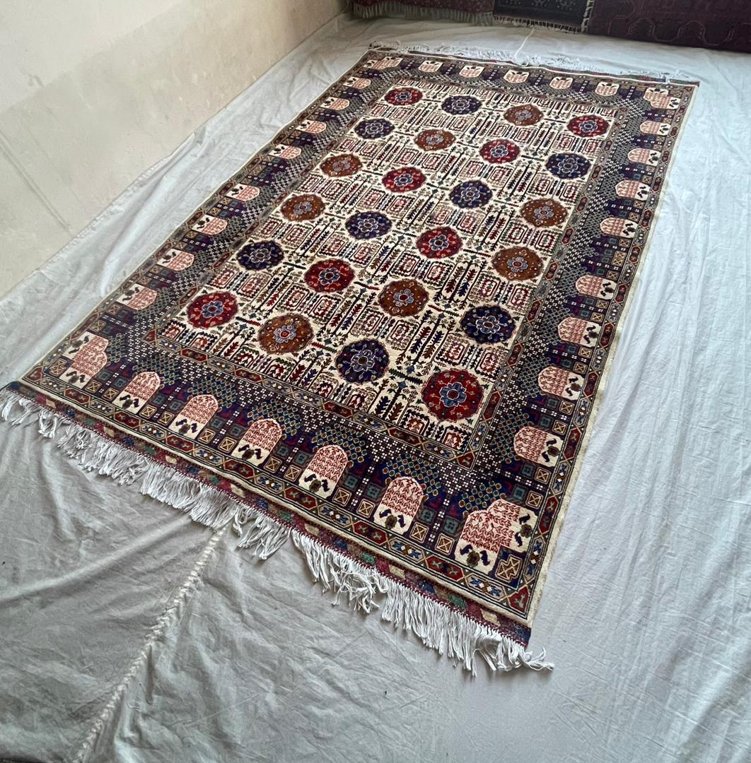Decorative rug with intricate patterns on a plain surface