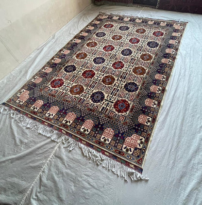 Decorative rug with intricate patterns on a plain surface