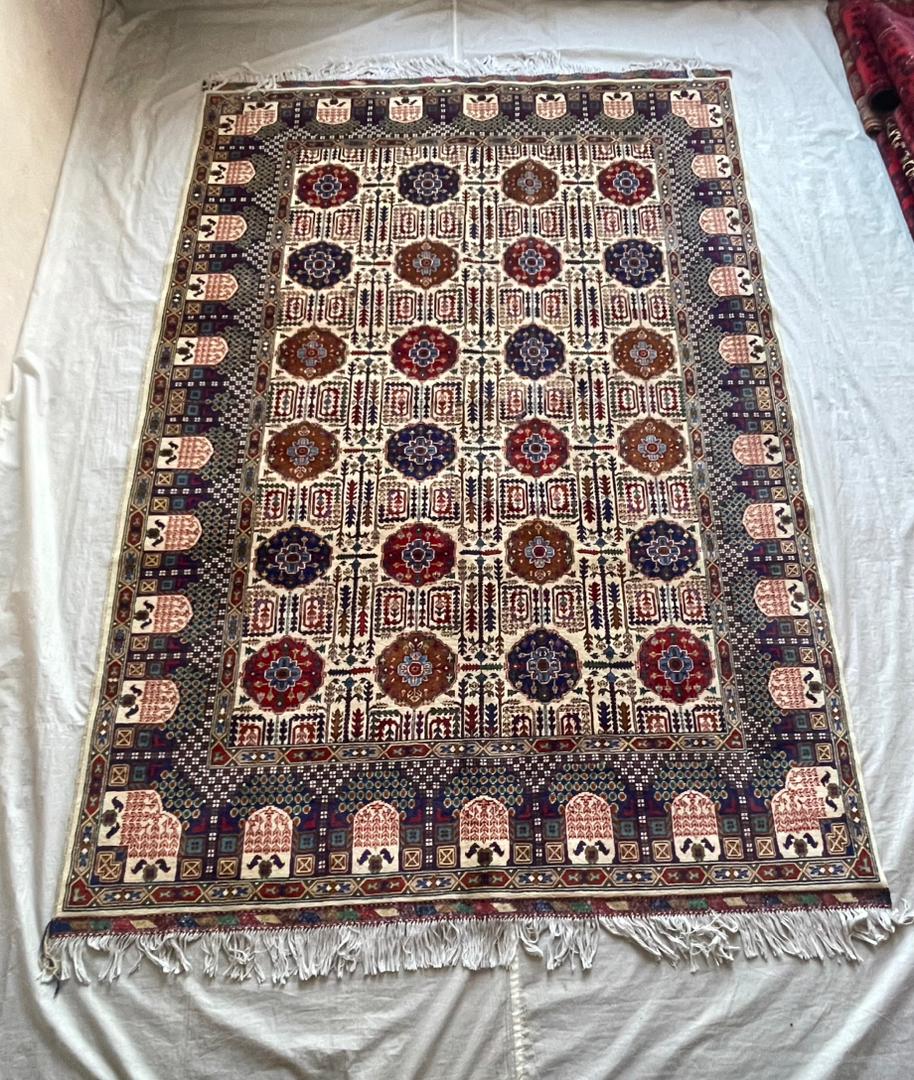 Decorative rug with intricate patterns on a plain background