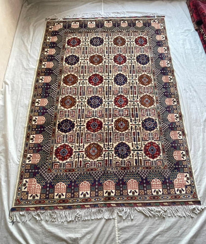 Decorative rug with intricate patterns on a plain background