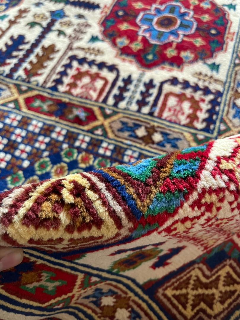 Close-up of a colorful patterned rug with intricate designs.